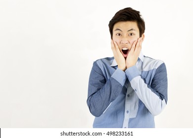 Asian Young Man Surprised, Shocked, Scared, With Hands On His Cheeks