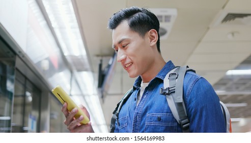 Asian Young Man Use 5g Smartphone On The Mrt Station