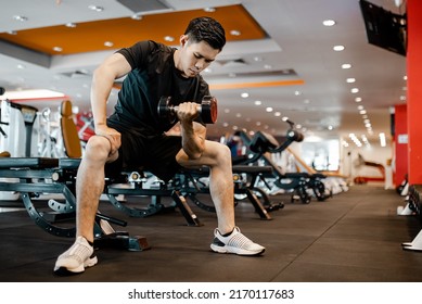 Asian Young Man Using Dumbbell Exercise At Gym For Good Healthy In Fitness, Lifestyle And Sport Exercise Concept.