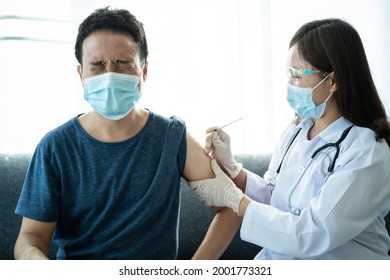 Asian Young Man Very Scare A Vaccination Shot, Man Having A Needle Phobia Problem And Feared While Shooting A Vaccine.