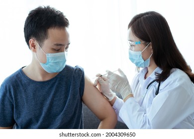 Asian Young Man Very Scare A Vaccination Shot, Man Having A Needle Phobia Problem And Feared While Shooting A Vaccine.