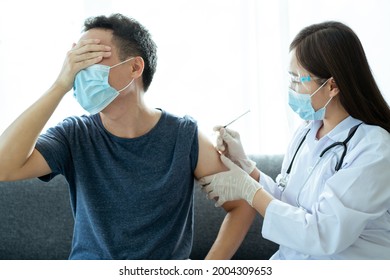 Asian Young Man Very Scare A Vaccination Shot, Man Having A Needle Phobia Problem And Feared While Shooting A Vaccine.