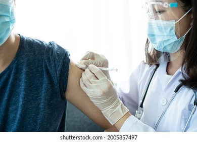 Asian Young Man Very Scare A Vaccination Shot, Man Having A Needle Phobia Problem And Feared While Shooting A Vaccine.