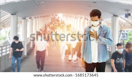 Asian young man wearing protective surgical face mask, cough and hurt at chest, air pollution from PM2.5 and coronavirus,covid-19 virus pandemic,air pollution concept