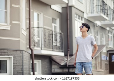 Asian Young Man Wearing Sunglasses Outdoors In The City
