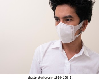 Asian young man in white shirt and medical mask to protect COVID-19