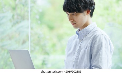 Asian young man working with a computer