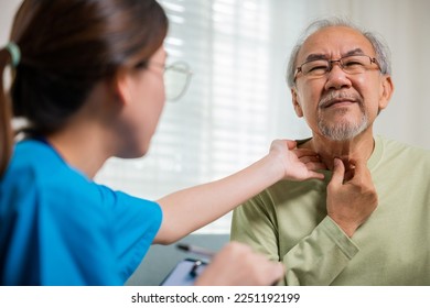 Asian young nurse checking senior man neck pain in clinic at retirement home, doctor woman examines lymph nodes on neck to determine if swollen, sore throat - Powered by Shutterstock