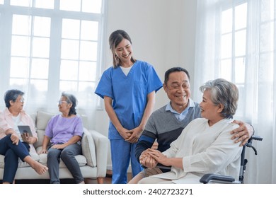 Asian young nurse support couple senior older man and woman in a wheelchair. elderly mature and a group of senior friends living in the hospital. socializing of retired people. - Powered by Shutterstock