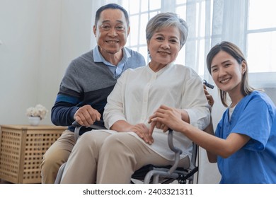 Asian young nurse support couple senior older man and woman in a wheelchair. elderly mature and a group of senior friends living in the hospital. socializing of retired people. - Powered by Shutterstock