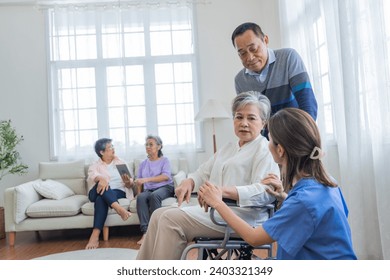 Asian young nurse support couple senior older man and woman in a wheelchair. elderly mature and a group of senior friends living in the hospital. socializing of retired people. - Powered by Shutterstock