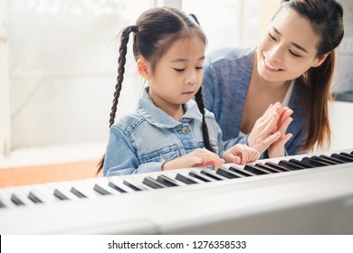 Asian Young Pianist Teacher Teaching Girl Kid Student To Play Piano, Music Education Concept