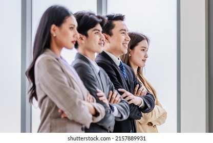 Asian Young Professional Successful Male And Female Businessmen And Businesswomen In Formal Business Suit Standing Side By Side Smiling Holding Hands Bonding United Together In Company Meeting Room.