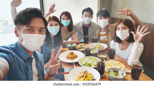 Asian Young Six Friends Wearing Face Mask Taking Selfie In Restaurant Happily