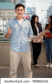 Asian Young Student Watching Exam Results In A Laptop In A Table Of An University Campus