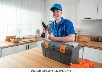 An Asian young Technician service man wearing blue uniform checking electrical appliances in home - Shutterstock ID 2249379745