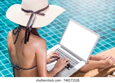 Asian Young Woman In Big Hat Relaxing On Poolside With Laptop Computer Blue Water