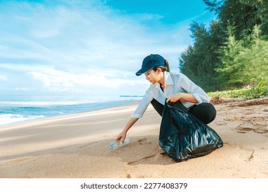 Asian young woman Cleaning  and collecting trash on the beach - Powered by Shutterstock