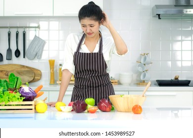 Asian young woman Cooking in the kitchen.With stress