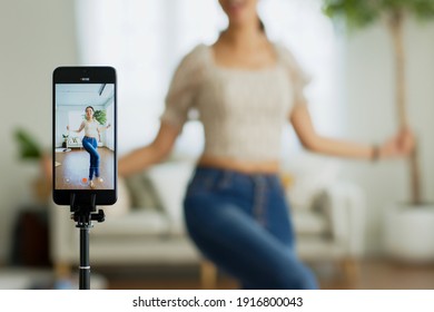 Asian young woman created her dancing video by smartphone camera. To share video to social media application.