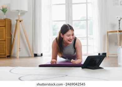 Asian young woman doing plank exercise at home. sport, fitness and healthy lifestyle concept - Powered by Shutterstock