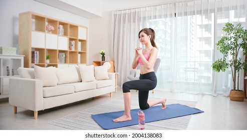 Asian Young Woman Is Doing Squats Exercise At Home