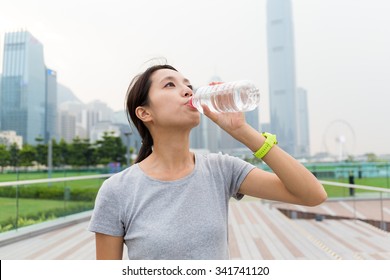 Asian Young Woman Drink Of The Water Bottle