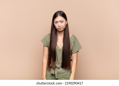 Asian Young Woman Feeling Sad And Whiney With An Unhappy Look, Crying With A Negative And Frustrated Attitude