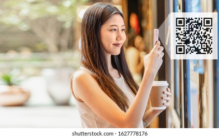 Asian young woman hand using smart mobile phone scanning bar code and QR code to movie tickets machine for buy and get the coupon in department store,lifestyle and leisure, technology scanner concept