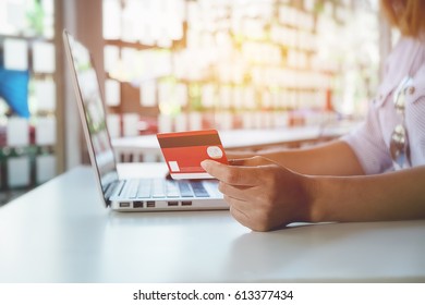 asian young woman hands holding credit card and using laptop smart phone Online shopping.Online shopping concept