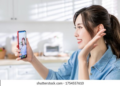 Asian Young Woman Has Video Chat With Friend By Mobile Phone Happily