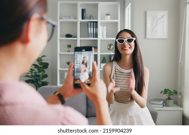 Asian young woman with her friend tiktoker created her dancing video by smartphone camera together. To share video on social media application  - Shutterstock ID 2159904239
