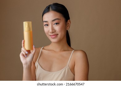 Asian Young Woman Holding Bottle Of Hair Spray