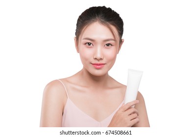 Asian Young Woman Holding Tube Of Moisturizer, Sun Cream.