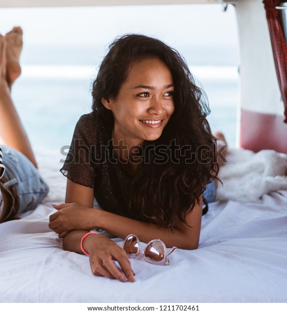 asian young woman lay down inside an old vintage van\
like home