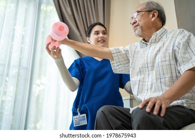 Asian young woman nurse at home nursing care support disabled senior elderly man. Caregiver Therapist serve physical therapy for older patient exercise with dumbbell. Physiotherapist Insurance concept