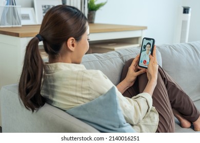 Asian Young Woman Patient Talking Virtual Online With Medical Doctor. Attractive Physician Man Giving Telehealth Telemedicine Video Call For Internet Consult Diagnosis Treatment To Sick Girl At Home.