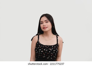 An Asian young woman poses for the camera for a studio shot isolated on a white background. - Shutterstock ID 2211775237