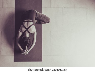 Asian young woman practicing yoga in  gray background.Young people do yoga indoor.