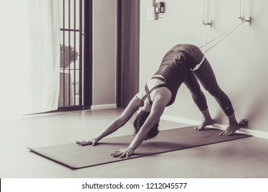 Asian young woman practicing yoga in  gray background.Young people do yoga at home. Color style sepia.