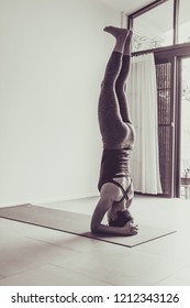 Asian young woman practicing yoga in  gray background.Young people do yoga at home. Color style sepia.