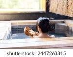 Asian Young woman relaxing in hot spring