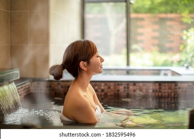 Asian Young Woman Relaxing In Hot Spring