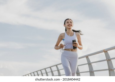 Asian young woman running outdoor, healthy lifestyle, and sport concepts
