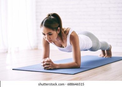 Asian Young Woman Standing In Plank Position