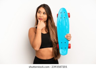 asian young woman thinking, feeling doubtful and confused. skate board concept - Powered by Shutterstock