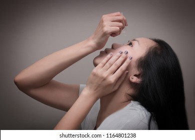 Asian Young Woman Uses Eye Drops For Eye Treatment. Redness, Dry Eyes, Allergy And Eye Itching