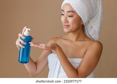 Asian Young Woman Using Moisturizing Lotion After Shower