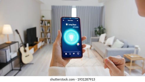 Asian Young Woman Is Using Smart Home App And Touch Screen To Turn On The Light By Mobile Phone