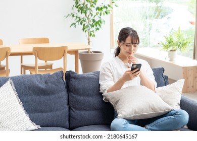 Asian Young Woman Using A Smartphone